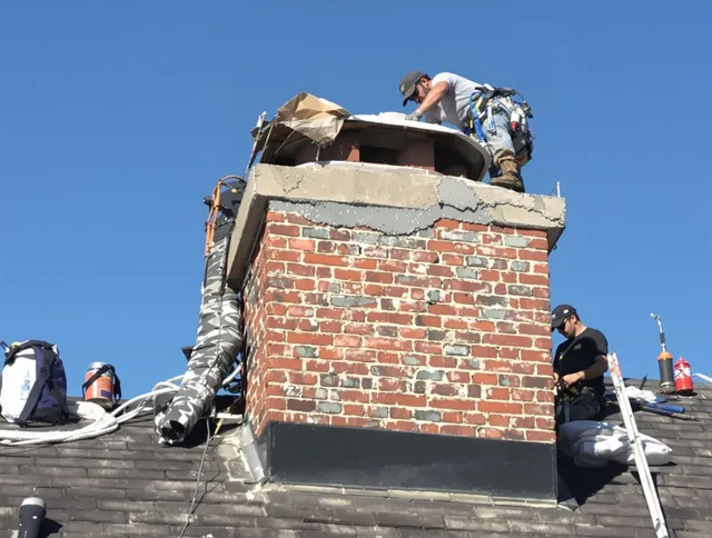 Danbury Chimney Sweep installing a custom chimney crown in Danbury, CT